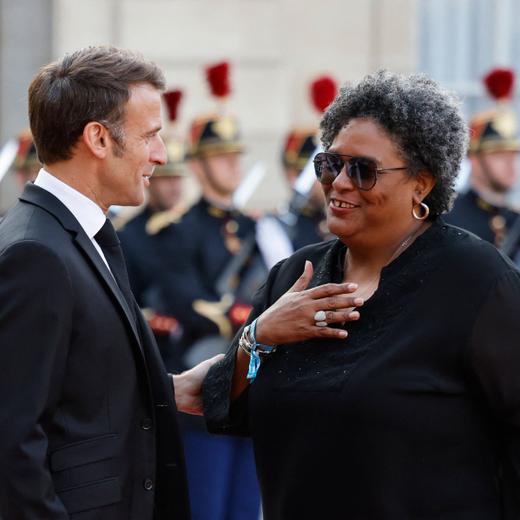 French President Emmanuel Macron (L) greets Barbadian prime Minister Mia Mottley (R) upon arrival for an official dinner at the Elysee Palace, on the sidelines of the New Global Financial Pact Summit, in Paris, on June 22, 2023. Dozens of global leaders are gathering in Paris on June 22 for a summit to tease out a new consensus on international economic reforms to help debt-burdened developing countries face a growing onslaught of challenges, particularly climate change. (Photo by Ludovic MARIN / AFP)