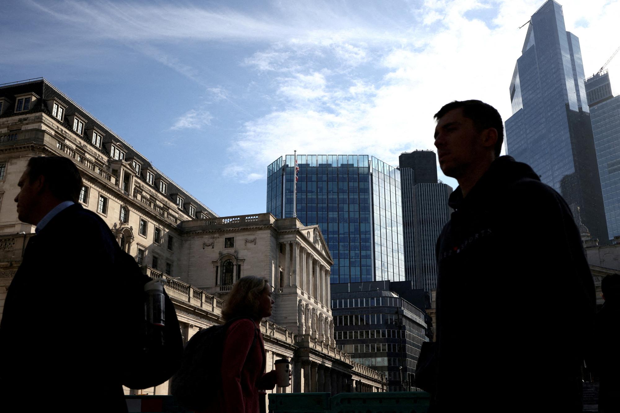 FILE PHOTO: People walk outside the Bank of England in the City of London financial district in London, Britain May 11, 2023. REUTERS/Henry Nicholls//File Photo