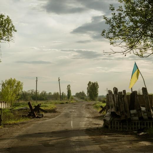 HULIAIPOLE, UKRAINE - MAY 11: A view of the old checkpoint at the exit of the city with Ukrainian flag as the Russia-Ukraine war continues in the frontline city of Huliaipole, Ukraine on May 11, 2023. The city is still heavy damaged and currently mostly bombed by planes. Currently around 2500 people still remain in the city that lack water and electrical power since March 2022. (Photo by Andre Alves/Anadolu Agency via Getty Images)