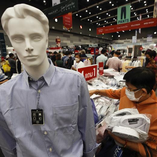 epa10716887 Shoppers buy discounted price clothes at Saha Group Fair shopping event in Bangkok, Thailand, 29 June 2023. The Saha Group Fair is a shopping event with more than 100 companies participating to offer discounted prices of consumer products, groceries and daily necessities at lower prices aimed to help consumers save expenses. Thailand's Gross Domestic Product (GDP) is forecasted to grow 3.9 percent in 2023 increase from earlier projected 3.6 percent mainly driven by raising private consumption and tourism recovery, according to the World Bank. EPA/RUNGROJ YONGRIT