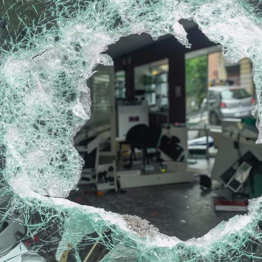 epa10720425 A view of a damaged establishment seen through a hole in a window following a night of looting and rioting in Montreuil, near Paris, France, 01 July 2023. Violence broke out across France over the fatal shooting of a 17-year-old teenager by a police officer during a traffic stop in Nanterre on 27 June.