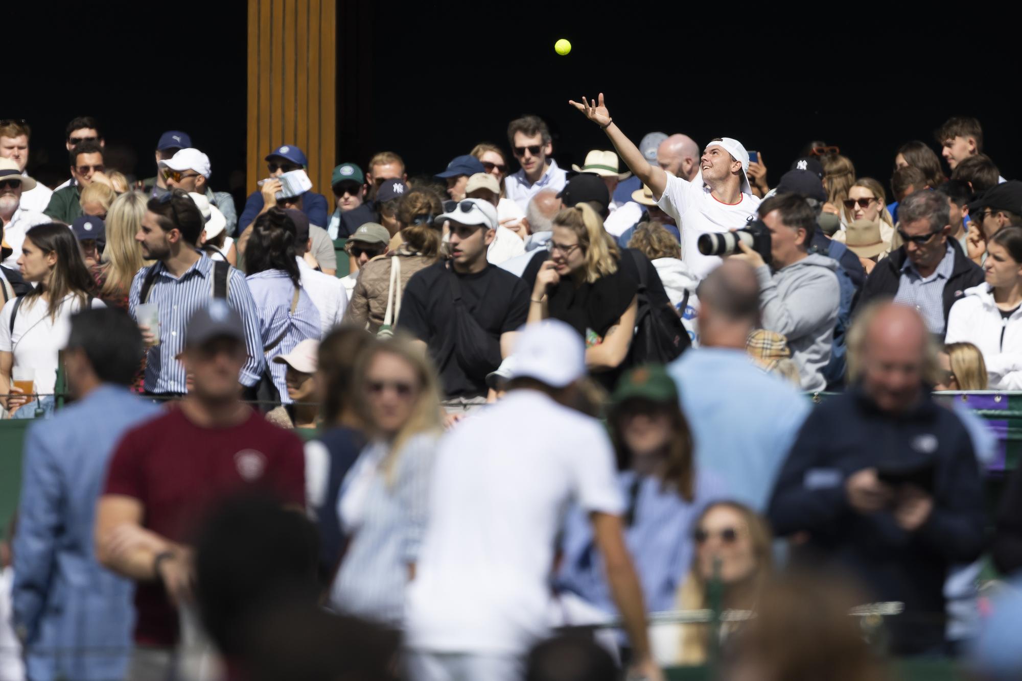 Dominic Stricker of Switzerland serves a ball during his first round match against Alexei Popyrin of Australia at the All England Lawn Tennis Championships in Wimbledon, London, Wednesday, July 5, 2023. (KEYSTONE/Peter Klaunzer)