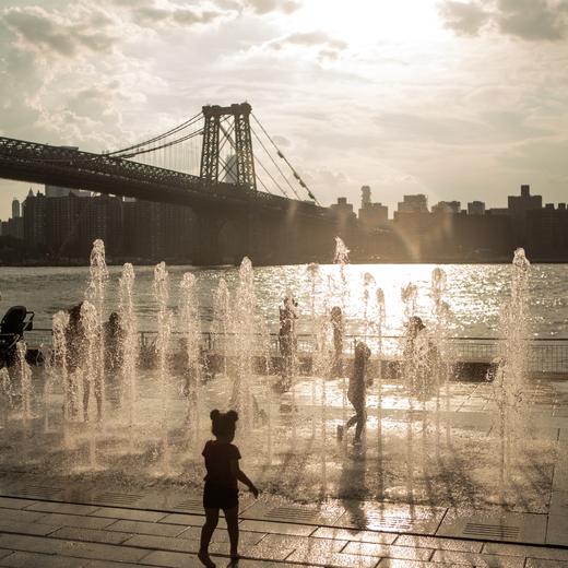The National Weather Service in NYC announced a heat advisory for extreme temeratures and humidity over the course of few days create dangerous conditions that can lead to heat stress and illness. People outdoor activities specially children around crystal fountains at Domino Park in Williamsburg,Brooklyn.in New York City temperatures remain in the 90's on Thursday and will remain for next few days. (Photo by Jashim Salam/NurPhoto) (Photo by Jashim Salam / NurPhoto via AFP)