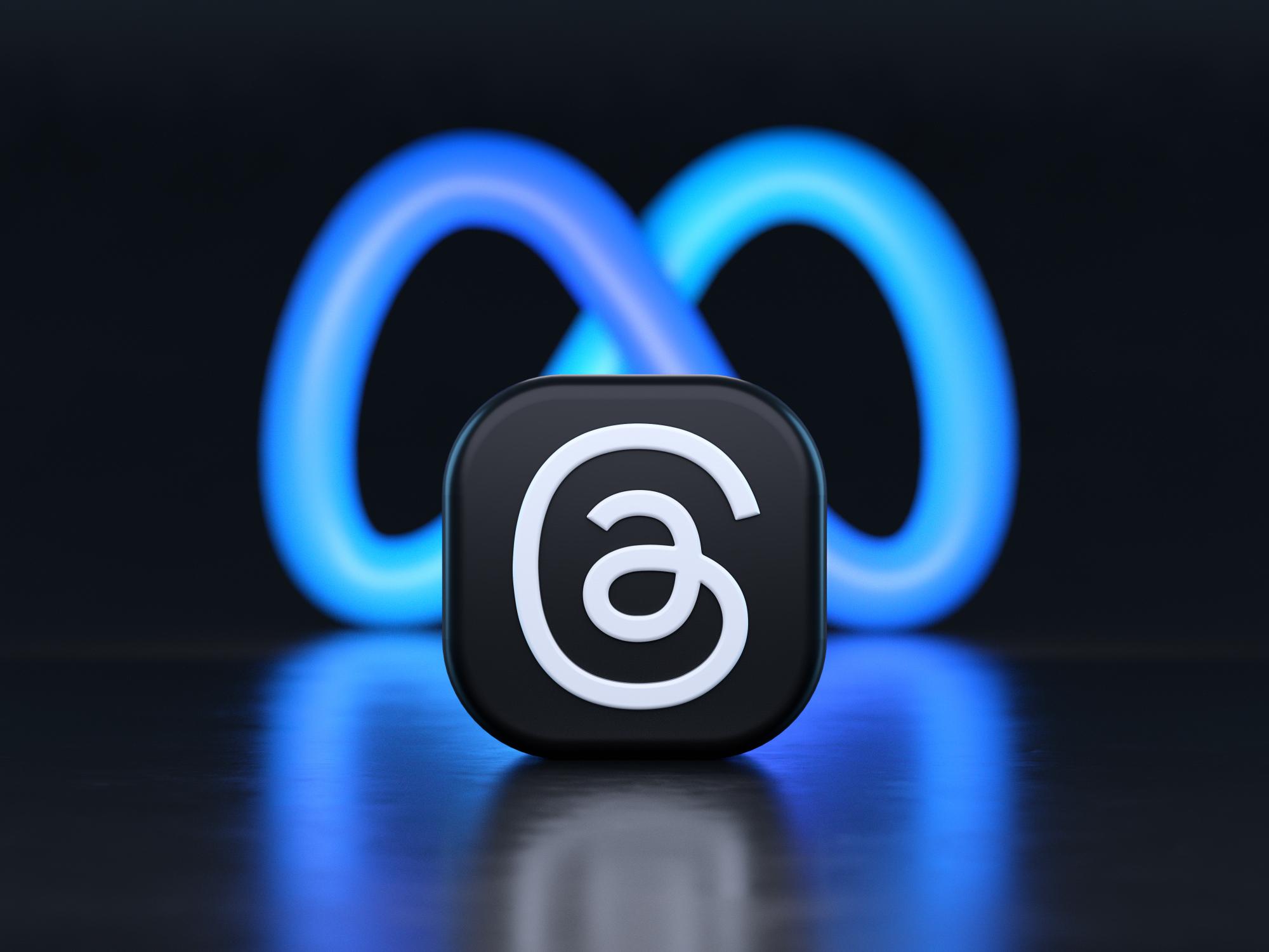 Valencia, Spain - July, 2023: Threads, an Instagram app logo in front of Meta symbol background in 3D rendering. Threads is a new social media app for microblogging as a rival of Twitter