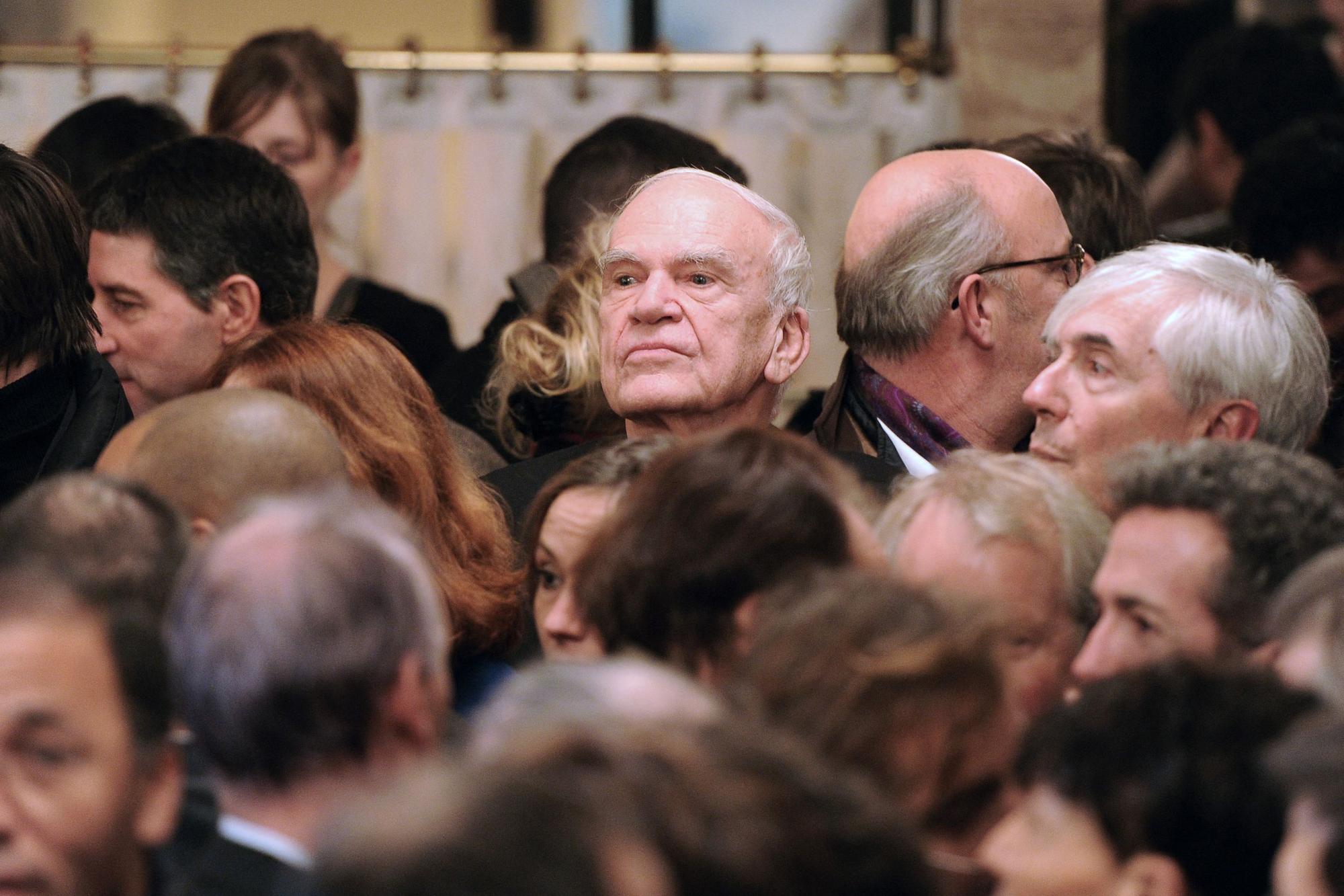 (FILES) Czech-born writer Milan Kundera (back C) attends the 20th anniversary party of the French philosopher Bernard-Henri Levy's review "La regle du jeu" (The rules of the game) in Paris on November 30, 2010. Czech writer Milan Kundera, the author of "The Unbearable Lightness of Being", has died aged 94, said Anna Mrazova, spokeswoman for the Milan Kundera Library in his native city of Brno on July 12, 2023. (Photo by Miguel MEDINA / AFP)