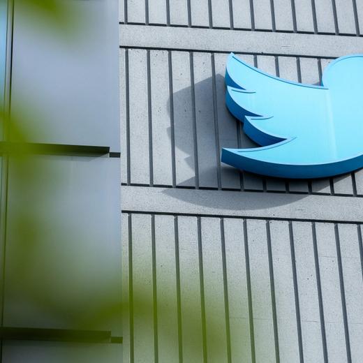 (FILES) The Twitter logo is seen on a sign on the exterior of Twitter headquarters in San Francisco, California, on October 28, 2022. Twitter owner Elon Musk said July 15 that the social media platform he bought for $44 billion last October has lost roughly half of its advertising revenue.  "We're still negative cash flow, due to ~50% drop in advertising revenue plus heavy debt load," the billionaire said in a post, responding to a user who was giving suggestions on financing for the platform. (Photo by Constanza HEVIA / AFP)