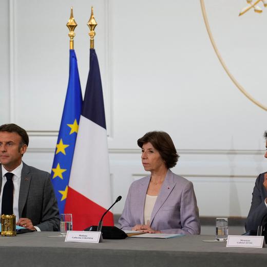 French President Emmanuel Macron speaks next to Foreign Affairs Minister Catherine Colonna and newly named Education Minister Gabriel Attal during a cabinet meeting after a cabinet reshuffle, at the Elysee Palace in Paris, France, July 21, 2023. Christophe Ena/Pool via REUTERS