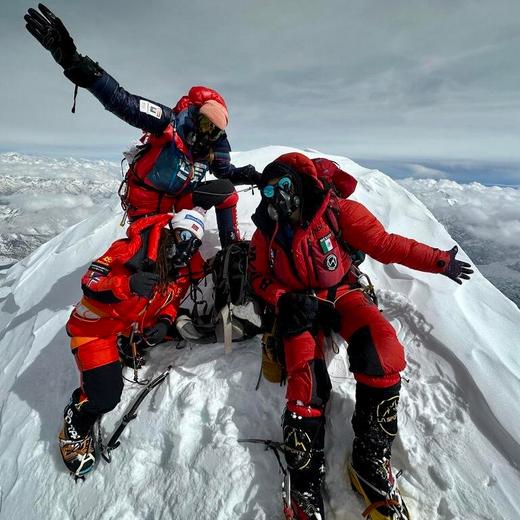 TOPSHOT - This handout photograph taken on April 26, 2023 and released on June 26, 2023 shows Norwegian Kristin Harila (down L), French, Swiss and Canadian Sophie Lavaud (upper L) and Mexican Viridiana Alvarez (R) posing on top of the Shishapangma summit in Tibet, the 13th summit of more than 8000m that the French climbed. At the age of 55, Sophie Lavaud has made French mountaineering history: on June 26, 2023, she became the first French woman and man to have climbed all fourteen of the world's 8,000-meter peaks. (Photo by Lama TENJING / Lama TENJING / AFP) / RESTRICTED TO EDITORIAL USE - MANDATORY CREDIT "AFP PHOTO / LAMA TENJING SHERPA " - NO MARKETING NO ADVERTISING CAMPAIGNS - DISTRIBUTED AS A SERVICE TO CLIENTS