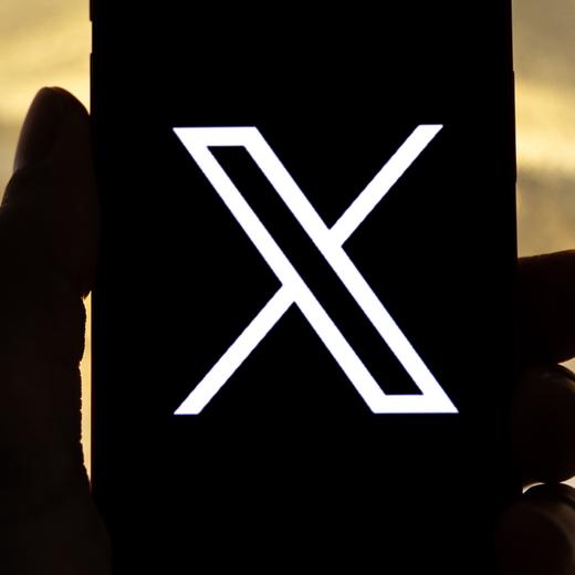 epa10772439 An illustration pictures shows a user holding a mobile phone displaying the 'X' logo, in Los Angeles, California, USA, 27 July 2023. Twitter announced on 23 July that it will rebrand to X. EPA/ETIENNE LAURENT