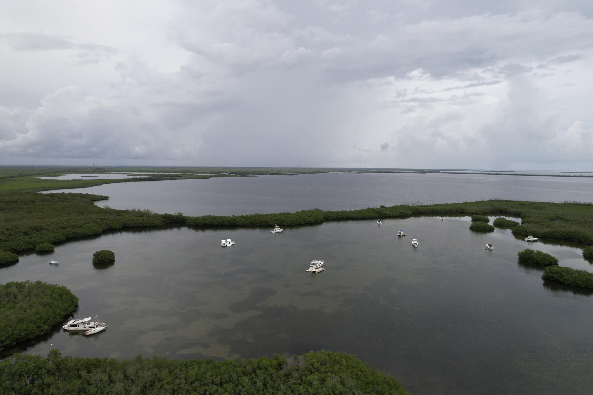 Boats are anchored at Manatee Bay off the Florida coast near Key Largo, on Friday, July 28, 2023. Triple-digit ocean temperatures are stunning even in Florida, where residents are used to the heat. (AP Photo/Daniel Kozin)