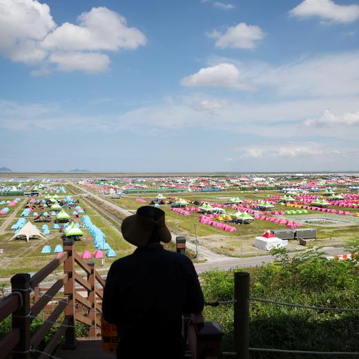 A resident looks at the camping site for the 25th World Scout Jamboree in Buan, South Korea, August 4, 2023. REUTERS/Kim Hong-Ji