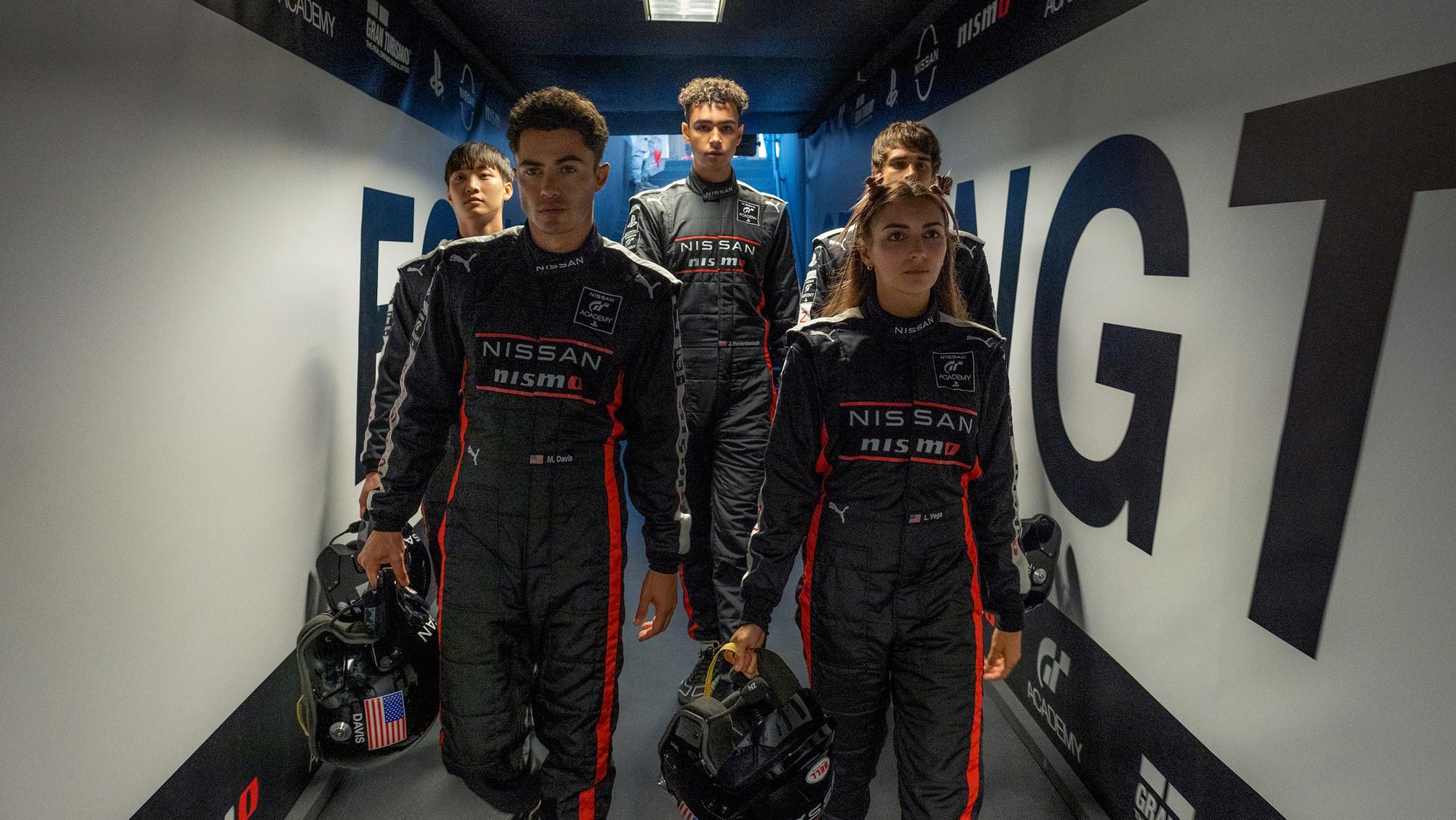 (l to r) Sang Heon Lee, Darren Barnet, Archie Madekwe, Emelia Hartford and Pepe Barroso Silva are GT Academy drivers in Columbia Pictures GRAN TURISMO. Photo by: Gordon Timpen