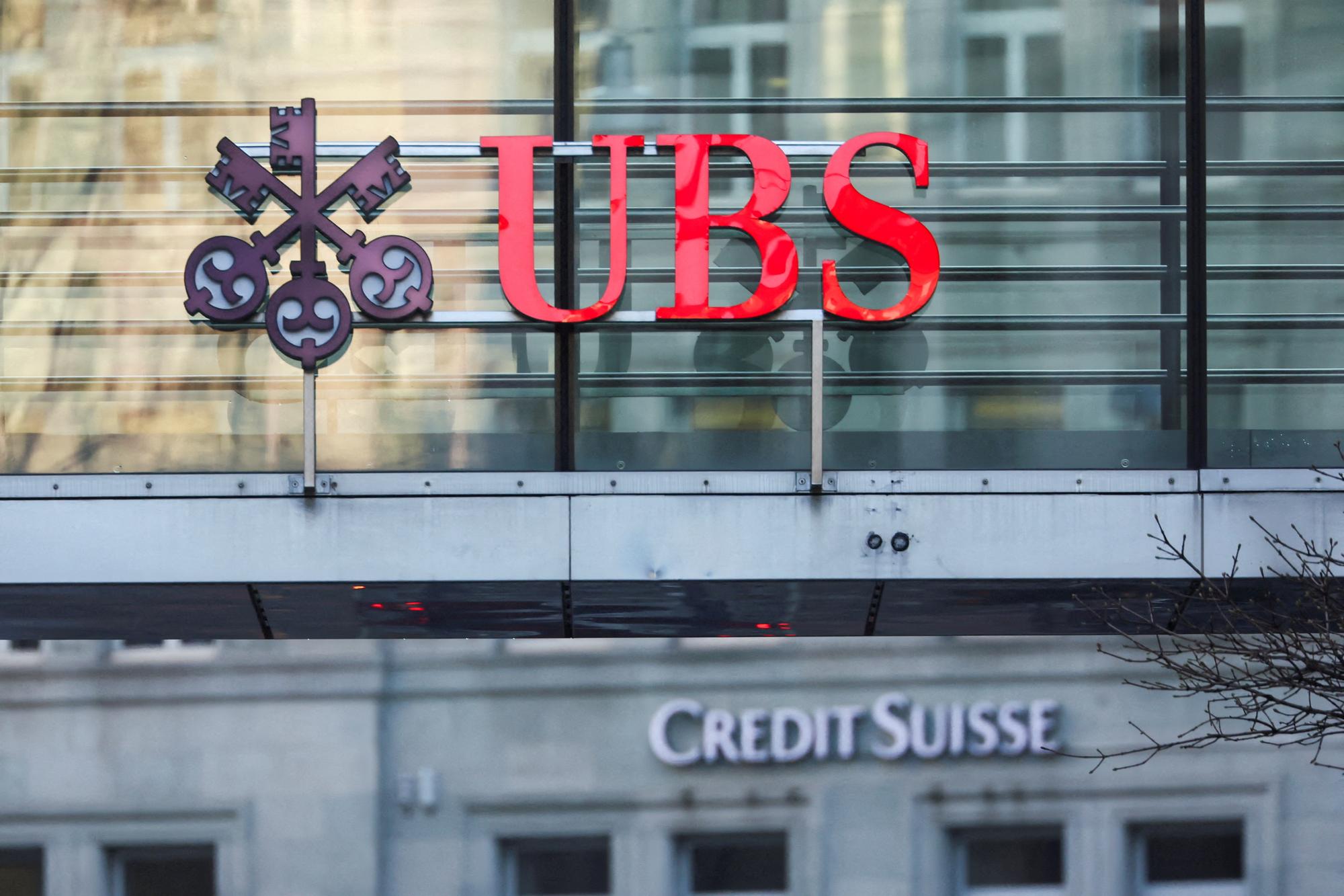 FILE PHOTO: Logos of Swiss banks UBS and Credit Suisse are seen in Zurich, Switzerland March 20, 2023. REUTERS/Denis Balibouse/File Photo