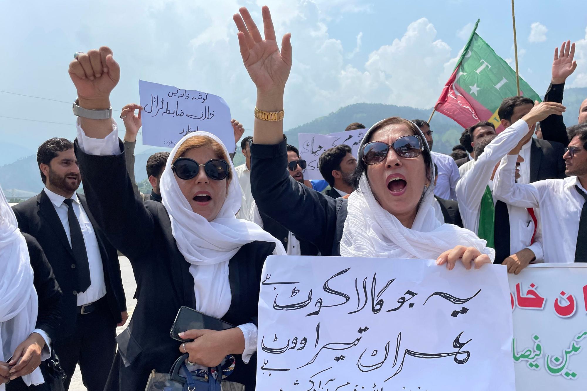 Pro-Pakistan Tehreek-e-Insaf (PTI) party lawyers shout slogans during a protest rally against the arrest of former Prime Minister Imran Khan, in Muzaffarabad, the capital of Pakistan-administered Kashmir on August 10, 2023. Pakistan's president ordered parliament dissolved late on August 9, opening the door to a caretaker government that will usher in elections in which the country's most popular politician, Imran Khan, has been sidelined. (Photo by Sajjad QAYYUM / AFP)