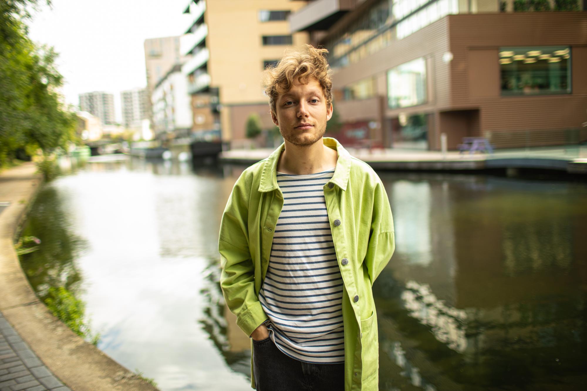 Gaspar Narby, musician, photographed along the Grand Union Canal in Central London. Gaspar Narby is a 26 year-old Swiss multi-instrumentalist, songwriter and producer based in London who released his debut single Home in Summer of 2017. Inspired by Bonobo, Sufjan Stevens, and Massive Attack, he fuses downtempo melancholia, pop dazzle, and singer-songwriter spirit with lush arrangements and electronic textures. Gaspar Narby studied Popular music at Goldsmith University in London. He caught the eye of Mixmag (New Artists of January 2020, print edition), Complex, Wonderland Magazine, IndieShuffle, Earmilk and AcidStag among others, with his music being featured on playlists such as New Music Friday UK, The Other List, Our Generation, Indie Garden and Your Office Stereo.