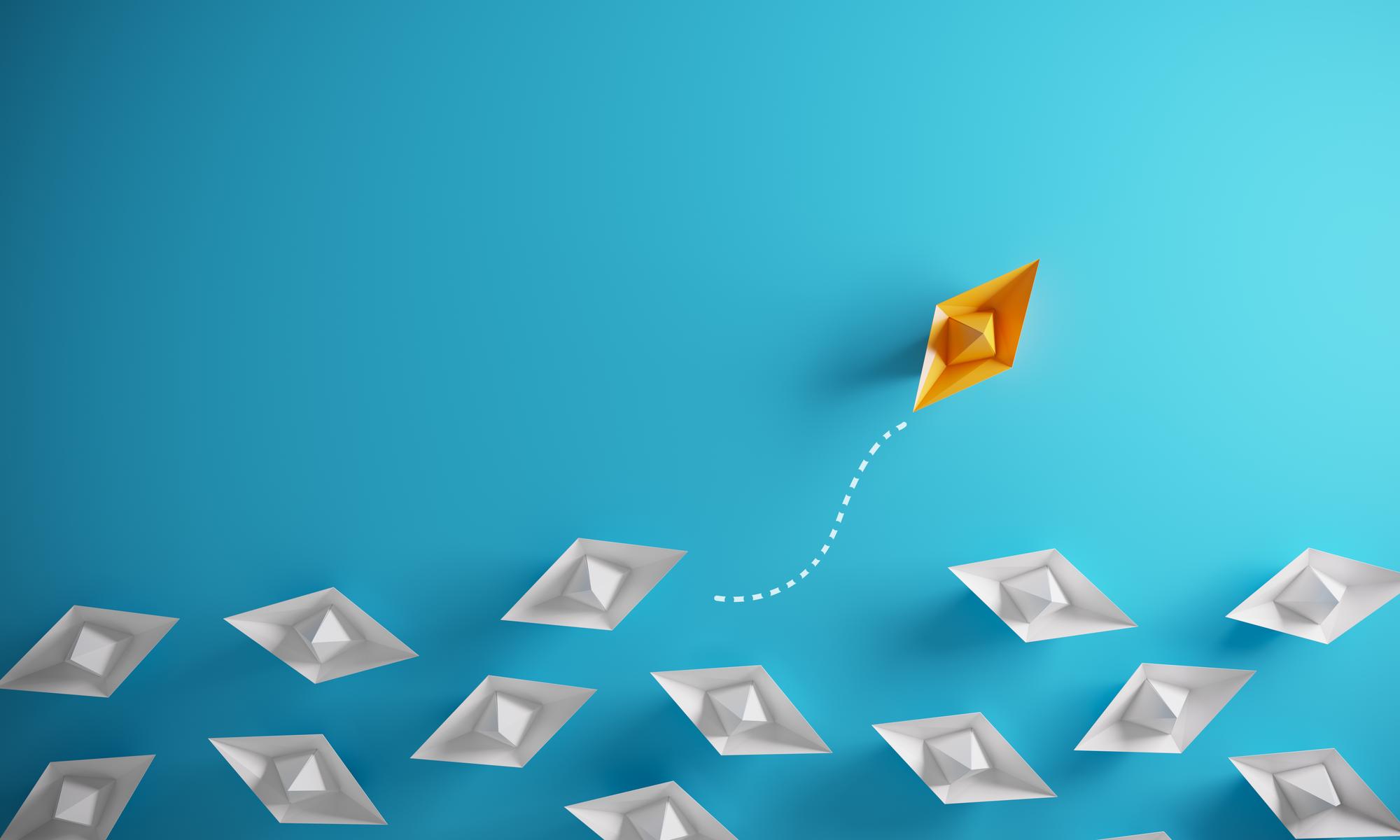 Group of paper boats in one direction and one individual pointing in the different way, can be used leadership/individuality concepts.( 3d render )