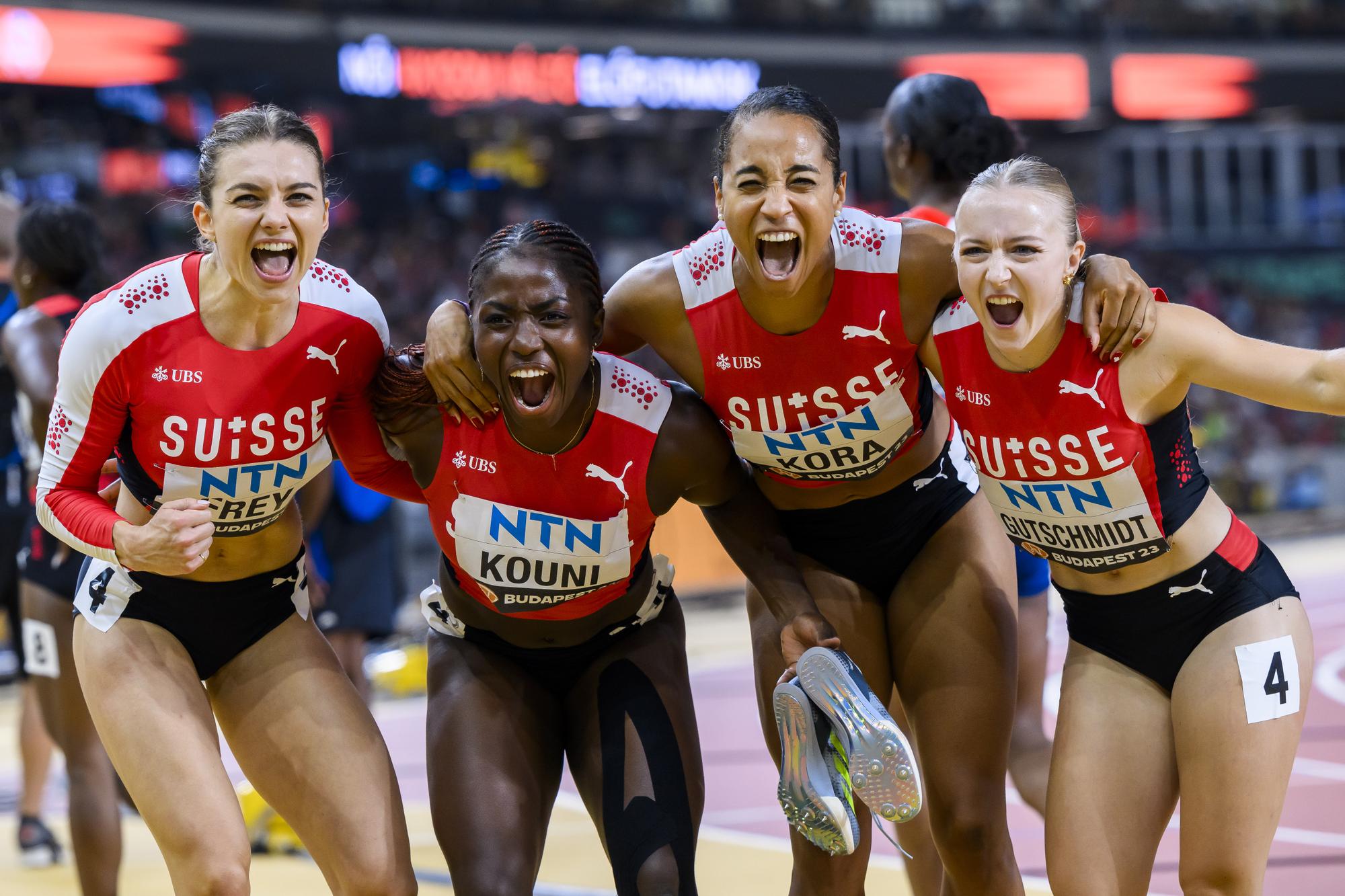 Geraldine Frey, Natacha Kouni, Salome Kora and Melissa Gutschmidt of Switzerland react during the women's 4x100 meters relay qualification of the World Athletics Championships at the National Athletics Centre, in Budapest, Hungary, Friday, August 25, 2023. (KEYSTONE/Jean-Christophe Bott)