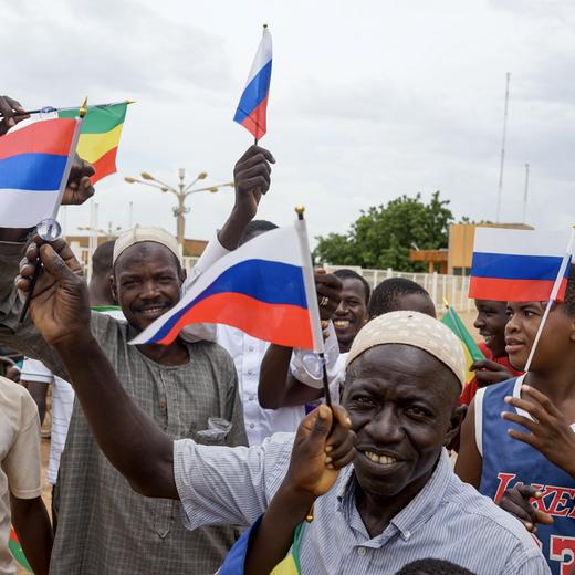 epa10822197 Supporters of the junta wave Russian flags during a rally in Niamey, Niger, 26 August 2023. About 20,000 people attended a rally at the Seyni Kountche stadium to support the junta, a day after the French ambassador was ordered to leave the country in 48 hours. EPA/ISSIFOU DJIBO