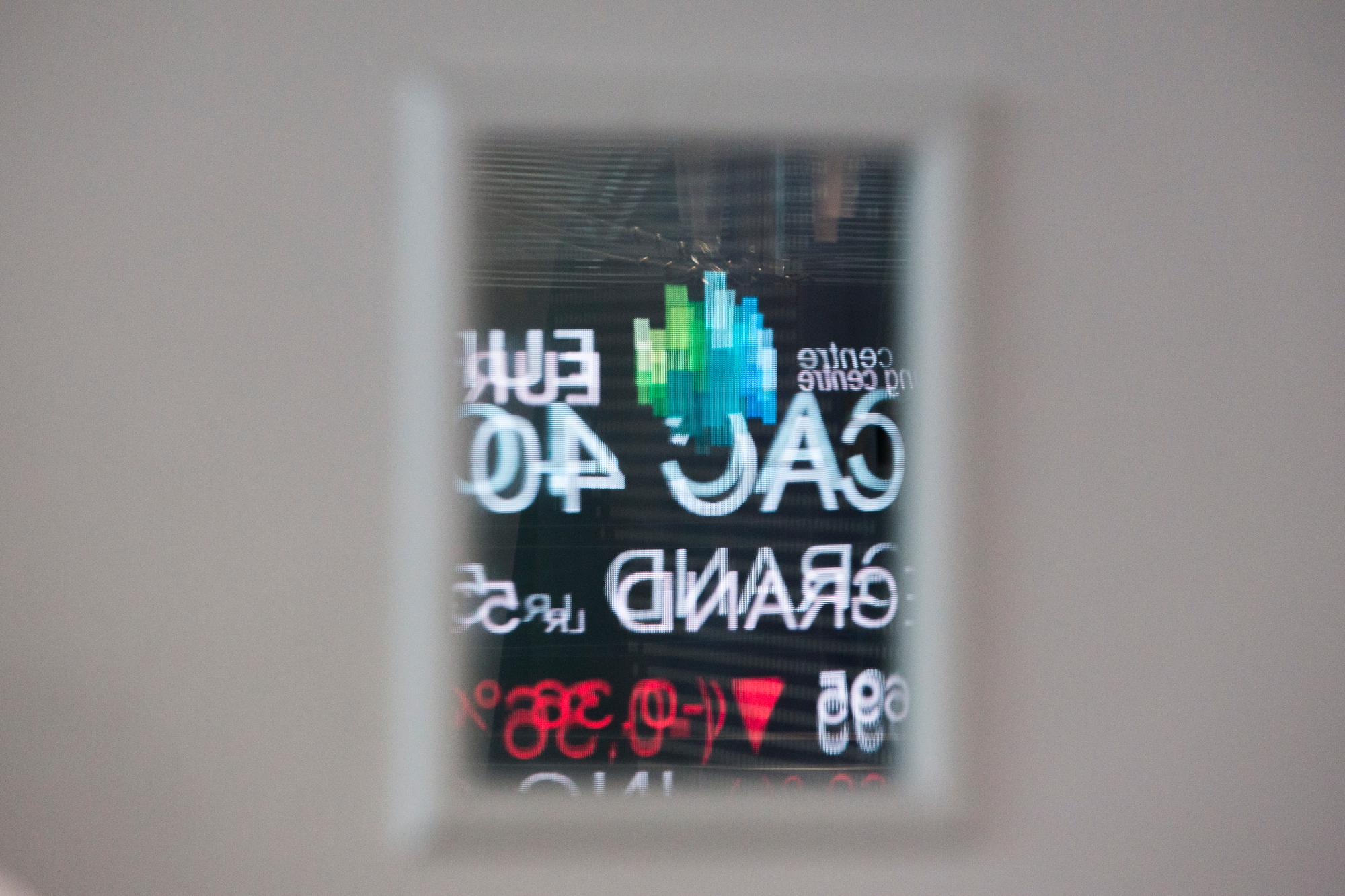 Reflected in a door mirror-window, a board shows indexes at the Euronext headquarters in the business district la Defense, outside Paris, Tuesday, Jan. 10, 2017. Euronext is a cross-border European stock exchange, created in 2000 from the merger of the Amsterdam, Brussels and Paris stock exchanges and later with the NYSE Group, resulting in the formation of NYSE Euronext in 2007. Euronext's goal is to serve the real economy by bringing together buyers and sellers. (AP Photo/Kamil Zihnioglu)