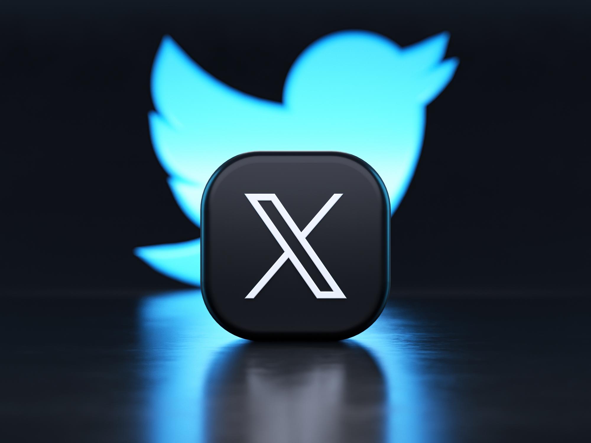 Valencia, Spain - July, 2023: X app logo in front of the Twitter blue bird symbol background in 3D rendering. X is the new name and logo of the social network Twitter owned by Elon Musk
