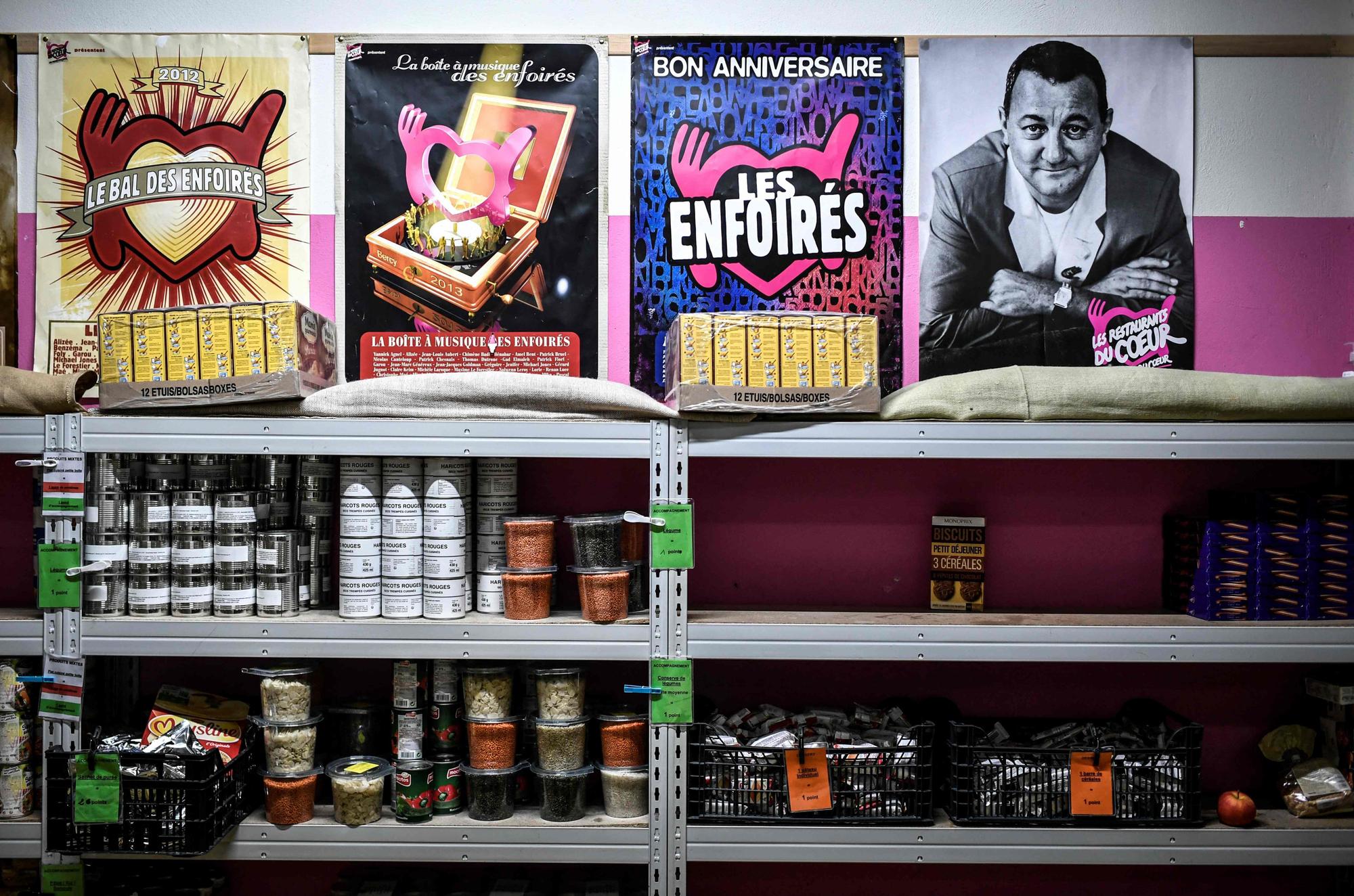 (FILES) This photograph taken on November 23, 2021, shows packages of food in a center of Les Restos Du Coeur (Restaurants of the Heart) association during the launch of the 37th winter campaign for food distribution to those in need, in Paris. Facing financial difficulties, Restos du Coeur has resigned itself to reducing the number of beneficiaries of its food aid program this winter, the association's president said on September 3, 2023. The late French humorist Michel Colucci, known as Coluche, founded the charity 'Les Restos du Coeur' which is now administered by his son Romain. (Photo by STEPHANE DE SAKUTIN / AFP)
