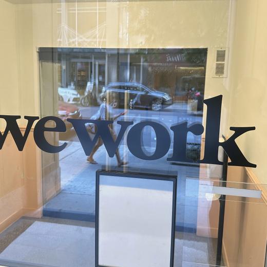 FILE - A sign for WeWork is displayed at the workspace-sharing office in the borough of Manhattan in New York, Aug. 9, 2023. WeWork will attempt renegotiate ?nearly all? of its leases, the company said Wednesday, Sept. 6weeks after the workspace-sharing company sounded the alarm over its ability to stay in business. (AP Photo/Ted Shaffrey, File)