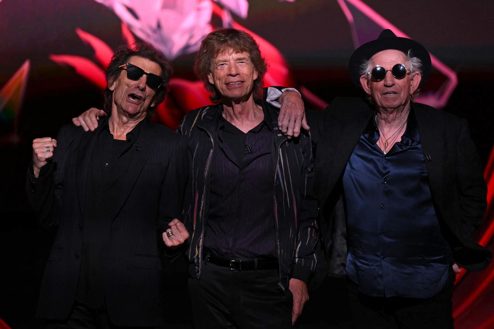 (L-R) Ron Wood, Mick Jagger and Keith Richards of legendary British rock band, The Rolling Stones pose on stage during a launch event for their new album, "Hackney Diamonds" at Hackney Empire in London on September 6, 2023, their first album of original material since 2005. The Rolling Stones will on Wednesday, September 6, reveal details of "Hackney Diamonds", the band's first studio album of new music since 2005, at a launch event in east London. (Photo by Daniel LEAL / AFP)