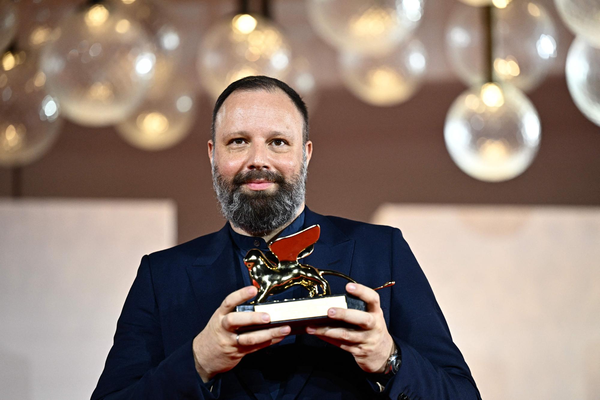 Director Yorgos Lanthimos poses with the Golden Lion for Best Film he reveived for 'Poor Things' during a photocall for winners at the 80th Venice Film Festival on September 9, 2023 at Venice Lido. (Photo by GABRIEL BOUYS / AFP)