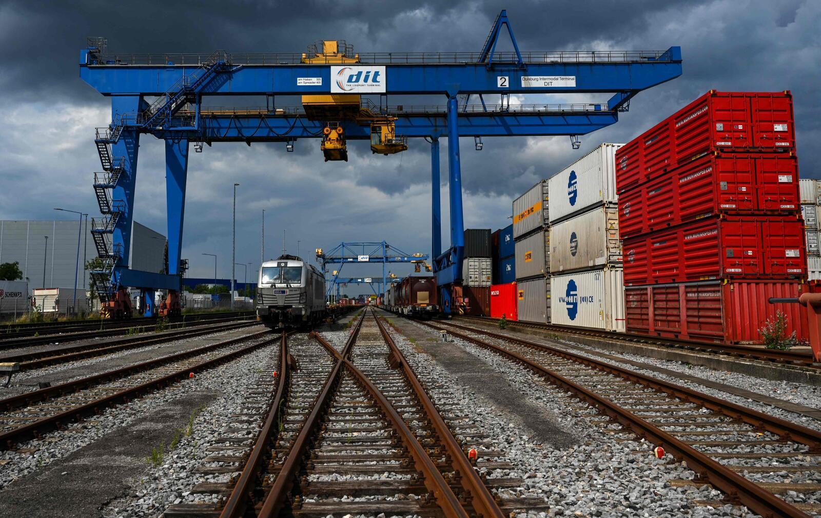 Containers are loaded from the railway at the seaport terminal DIT Duisburg Intermodal Terminal at the Duisburg harbour, on July 13, 2023. With the expansion of rail-bound freight traffic along the "New Silk Road", the port continues to expand its role as a hub or end point of the Silk Road, which connects China and numerous other Asian countries with the Port of Duisburg. (Photo by Ina FASSBENDER / AFP)