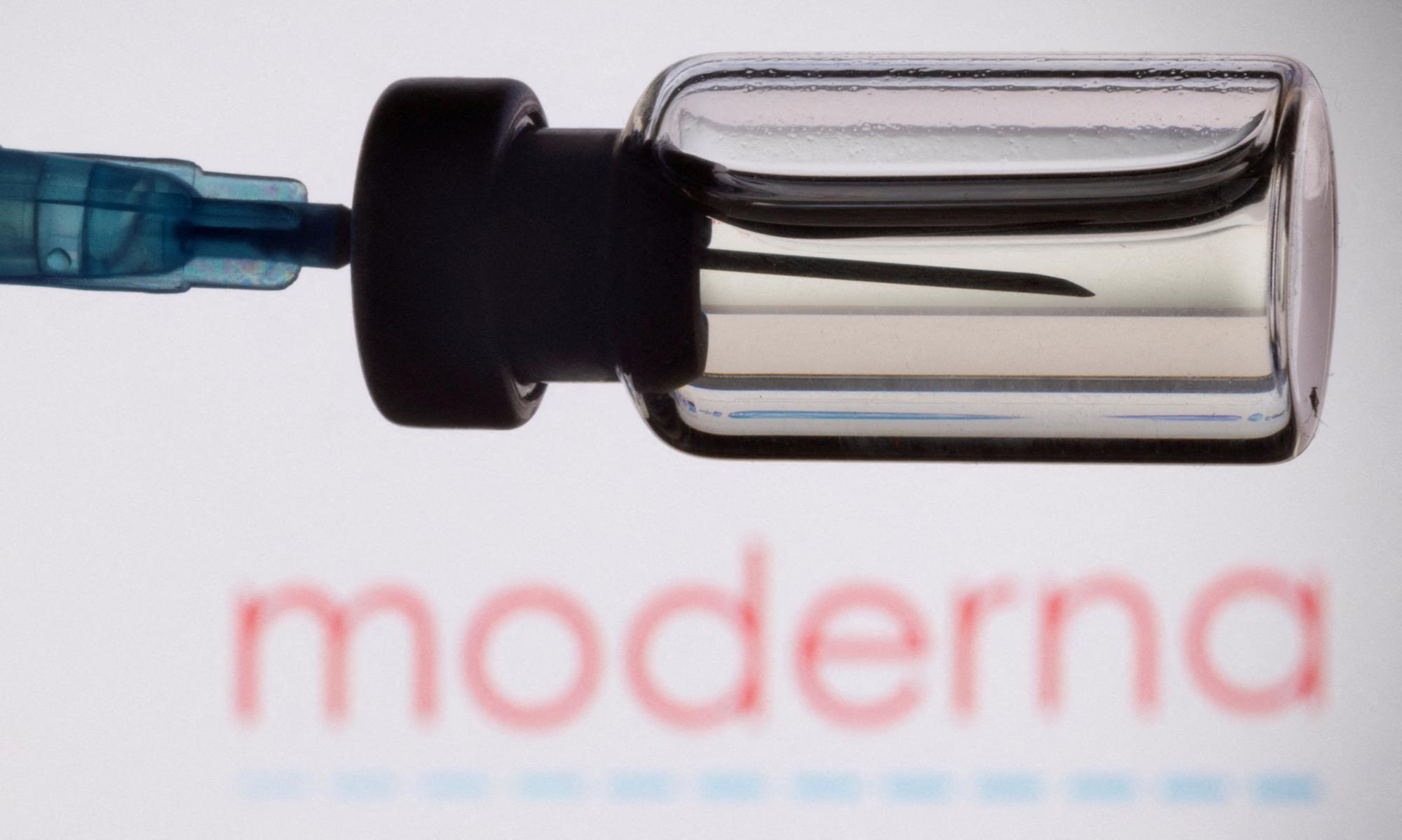 FILE PHOTO: A vial and a syringe are seen in front of a displayed Moderna logo, in this illustration taken, November 27, 2021. REUTERS/Dado Ruvic/Illustration/File Photo