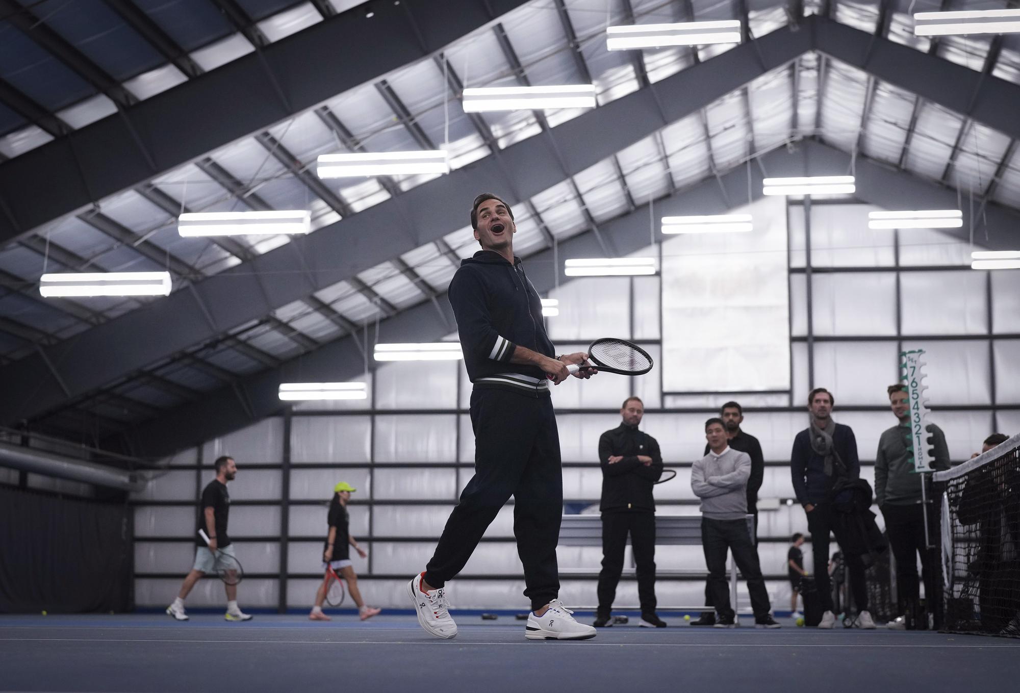 Retired tennis player Roger Federer reacts during a tennis clinic for kids from the Vancouver chapters of Big Brothers and Big Sisters, as part of a partnership with Mercedes-Benz Canada, in Vancouver, British Columbia, Tuesday, Sept. 19, 2023. Federer is in the city for the Laver Cup tennis tournament that he co-founded. (Darryl Dyck/The Canadian Press via AP)