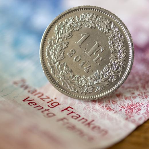 Eine Zwanzigernote und ein Einfraenkler, fotografiert in Basel, am Dienstag, 12. April 2022. Das basel-staedtische Stimmvolk hiess im Juni 2021 das kantonale Mindestlohngesetz mit 54 Prozent Ja-Stimmen gut. Es legt den Mindestlohn auf 21 Franken fest. Basel-Stadt ist der erste Deutschschweizer Kanton, der einen Mindestlohn einfuehrt. Der Regierungsrat hat nun das Inkraftsetzen des Mindestlohns beschlossen. (KEYSTONE/Georgios Kefalas)