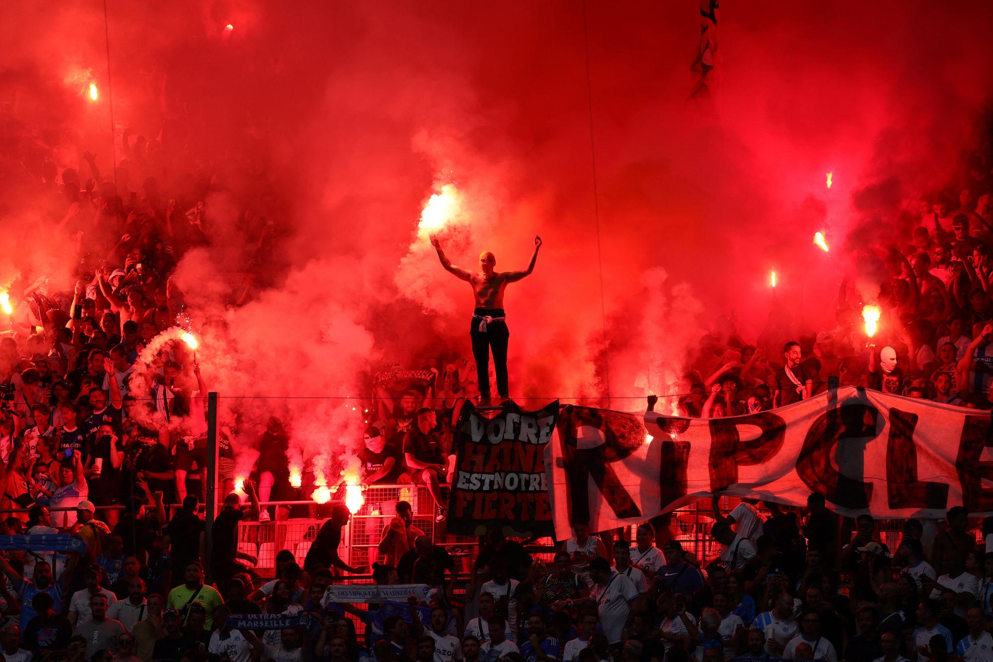 Marseille's supporters light flares prior to the pre-season friendly football match between Olympique Marseille (OM) and Bayer Leverkusen at the Stade Velodrome in Marseille, southern France on August 2, 2023. (Photo by CLEMENT MAHOUDEAU / AFP)