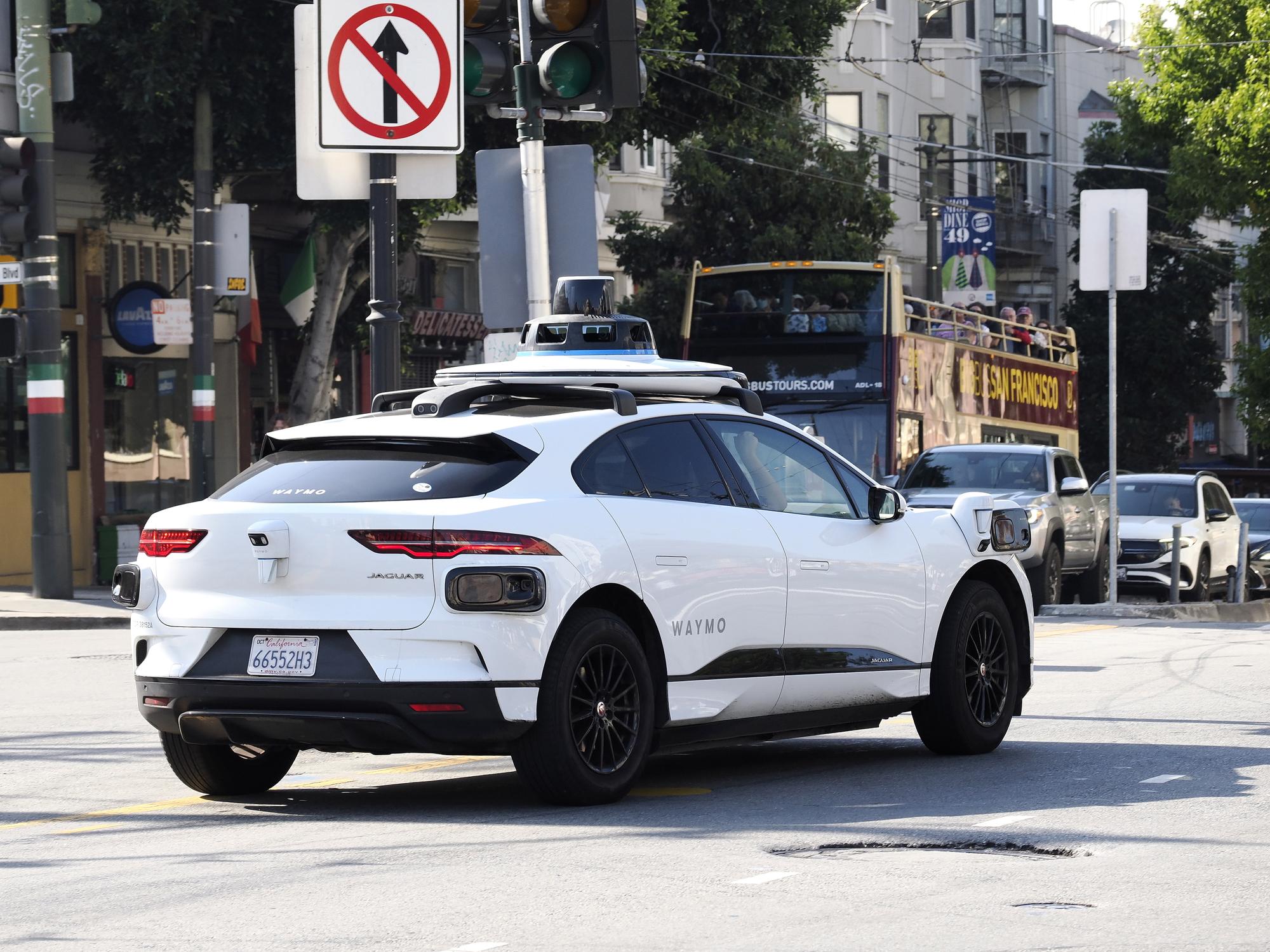 epa10875989 A Waymo autonomous vehicle makes its way through traffic in the North Beach district in San Francisco, California, USA, 21 September 2023. City of San Francisco officials, fire chief, and transportation chief are all requesting that Cruise and Waymo robotaxi operations temporarily be cut in half due to traffic disruptions and safety concerns. EPA/JOHN G. MABANGLO