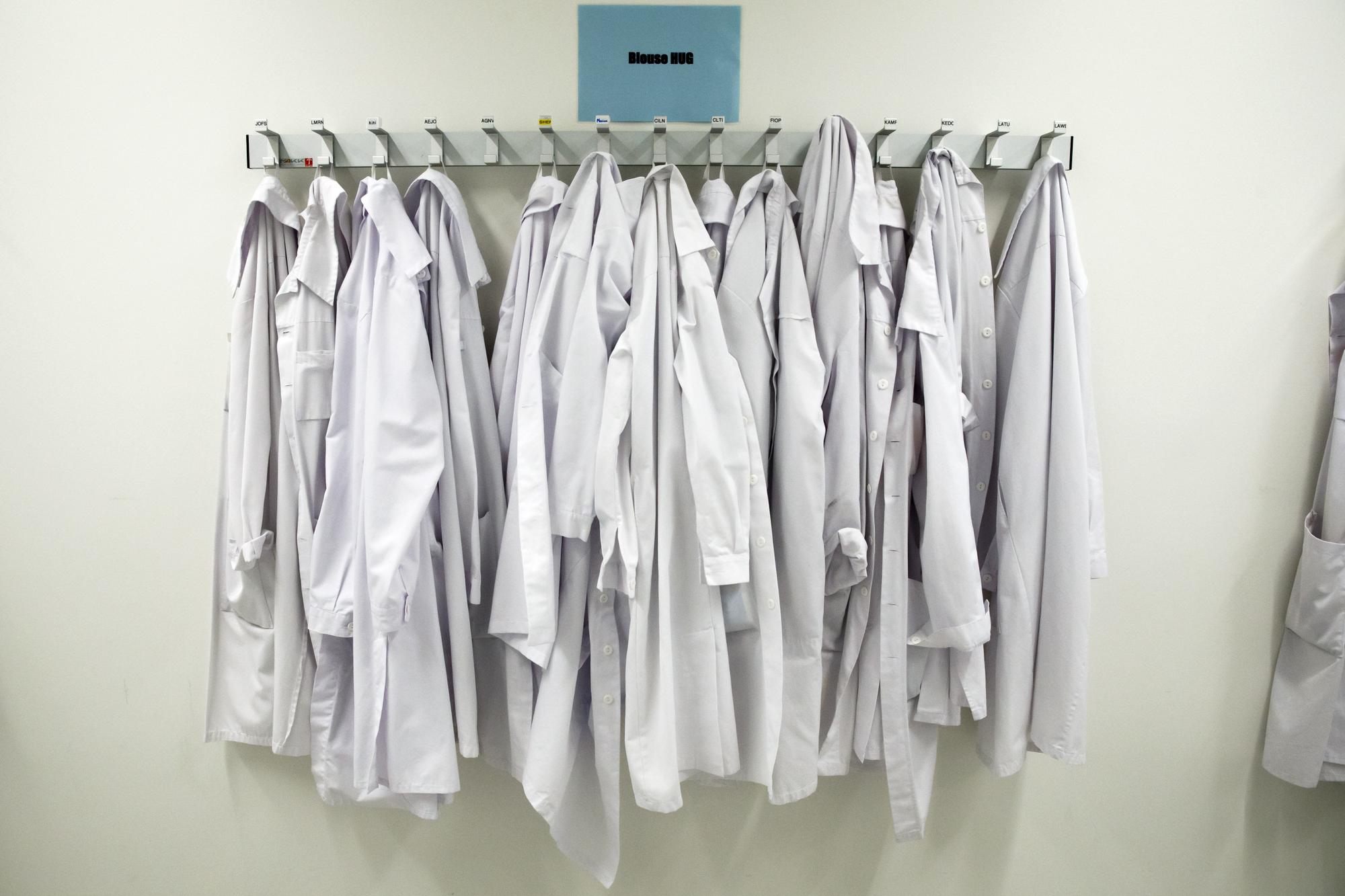 Lab coats are pictured in the virology laboratory of the Geneva University Hospitals (HUG) where its are testing the samples collected on persons suspected of being infected with the coronavirus COVID-19 (SARS-CoV2), in Geneva, Switzerland, Tuesday, March 10, 2020. (KEYSTONE/Salvatore Di Nolfi)