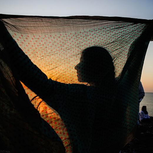 People gathered to watch the sun rising from the sea on July 1, 2019. People welcoming the first sunrise of July at the most Eastern part of Bulgaria, near the village of Kamen Bryag. The gathering is called July and is a Bulgarian tradition since 1980 ( usually people spend the night with friends at the beach and watch the sun rising on the 1st of July). This ritual is inspired by the hippi culture and the Uriah heep's classic July Morning and started as a rebellion again the comunistic regime in the country. For a while now the gathering is accompanied by a rock concert. For the July Morning in 2019, the star of the morning was Joe Lynn Turner (Deep Purple, Rainbow), Kamen bryag, Bulgaria on July 01, 2019 (Photo by Hristo Rusev/NurPhoto via Getty Images)