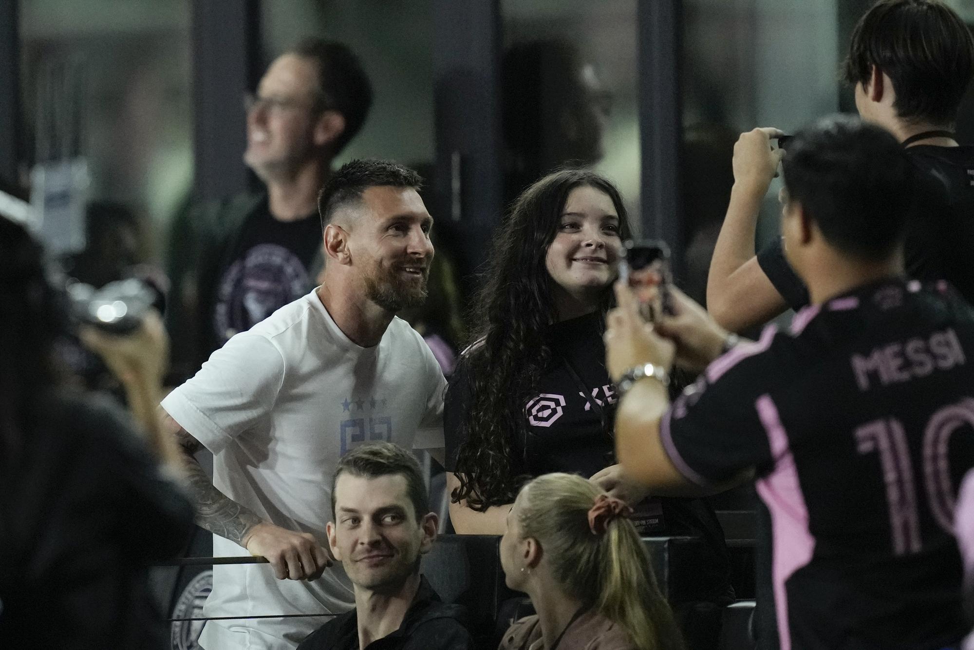 Inter Miami forward Lionel Messi, left, poses for pictures with fans after an MLS soccer match between Inter Miami and Charlotte FC, Wednesday, Oct. 18, 2023, in Fort Lauderdale, Fla. (AP Photo/Rebecca Blackwell)  Lionel Messi