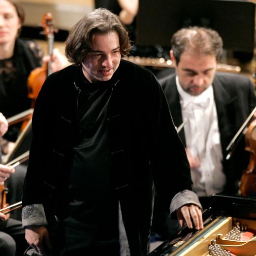Turkish pianist Fazil Say, center, plays during a performance at the World Economic Forum in Davos, Switzerland, Saturday Jan. 31, 2009. (AP Photo/Virginia Mayo)