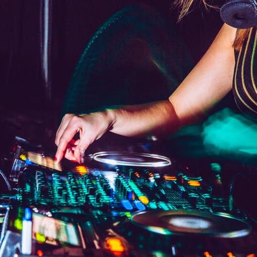 Close-up of Young Woman DJ Using Turntables.