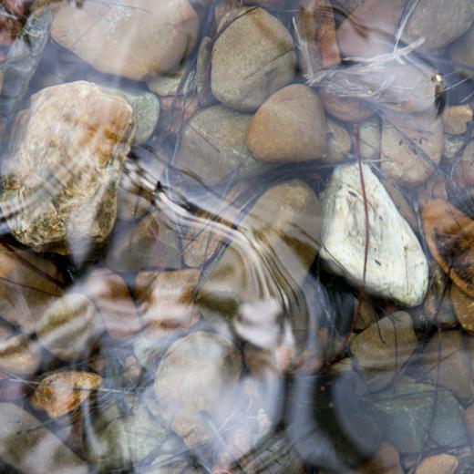 peaceful scene, water over pebbles