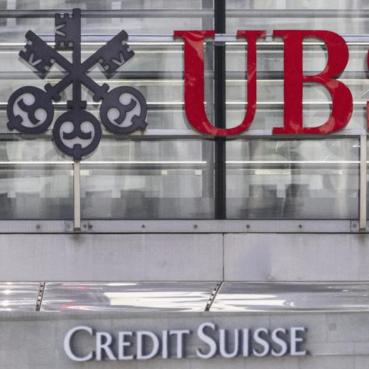 FILE - The logos of the Swiss banks Credit Suisse and UBS are pictured in Zurich, Switzerland, on June 12, 2023. UBS reported Tuesday Nov. 7, 2023 a $255 million pre-tax loss as the giant Swiss bank shed some 4,000 jobs globally, cut costs faster than expected, and reaped billions in asset inflows in the third quarter while moving forward with its government-orchestrated merger with rival Credit Suisse. (Ennio Leanza/Keystone via AP, File)