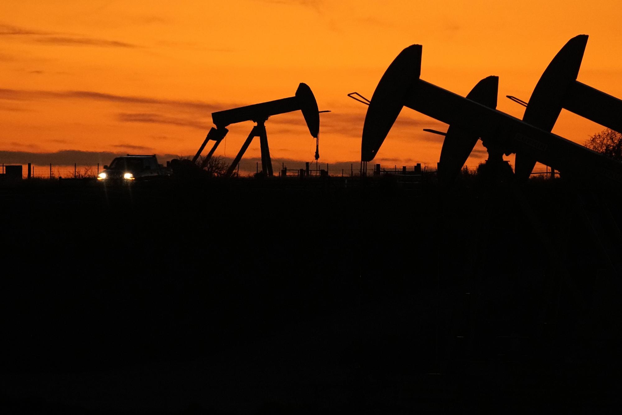 Oil Pump jacks work at dusk near Barnes City, Texas, Wednesday, Nov. 1, 2023. Despite frequent and devastating heat waves, droughts, floods and fire, major fossil fuel-producing countries still plan to extract more than double the amount of fossil fuels in 2030 than is consistent with the Paris climate accord?s goal for limiting global temperature rise, according to a U.N.-backed study released Wednesday, Nov. 8. (AP Photo/Eric Gay)