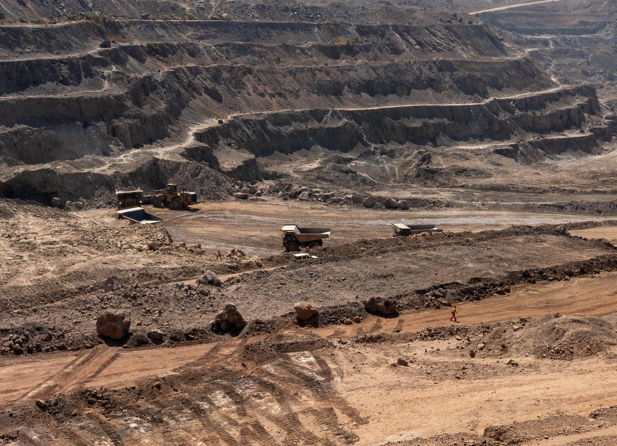 Trucks haul away ore from a pit in Tenke Fungurume Mine, one of the largest copper and cobalt mines in the world, owned by Chinese company CMOC, in southeastern Democratic Republic of Congo, on June 17, 2023. The Democratic Republic of Congo produces over 70 percent of the global supply of cobalt. The metal is a critical component of batteries and seen as key to the renewable energy transition. In Tenke Fungurume Mine, one of the largest copper and cobalt mines in the world, owned by Chinese company CMOC, in southeastern Democratic Republic of Congo. (Photo by Emmet LIVINGSTONE / AFP)