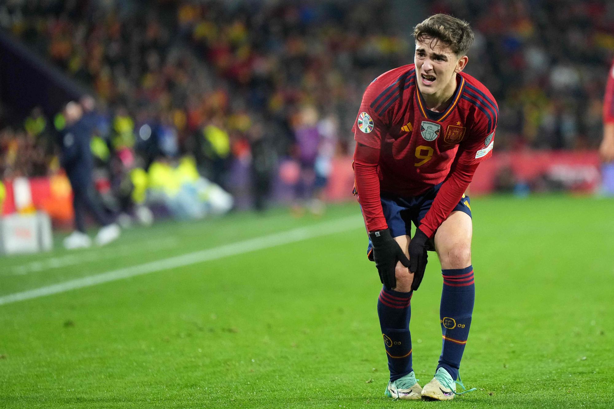(FILES) Spain's midfielder #09 Gavi reacts to injuring his knee during the UEFA Euro 2024 group A qualifying football match between Spain and Georgia at the Jose Zorrilla stadium in Valladolid on November 19, 2023. (Photo by CESAR MANSO / AFP)