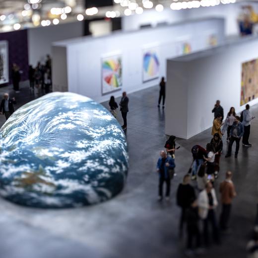 epa11014754 A picture taken with a tilt-shift lens shows people walking next to the piece 'Earth Play' by Seung-Taek Lee during the Art Basel art fair at the Miami Beach Convention Center in Miami Beach, Florida, USA, 06 December 2023. According to the organizers, thousands of art dealers, artists, collectors and art aficionados will enjoy modern and contemporary art from 277 galleries. EPA/CRISTOBAL HERRERA-ULASHKEVICH
