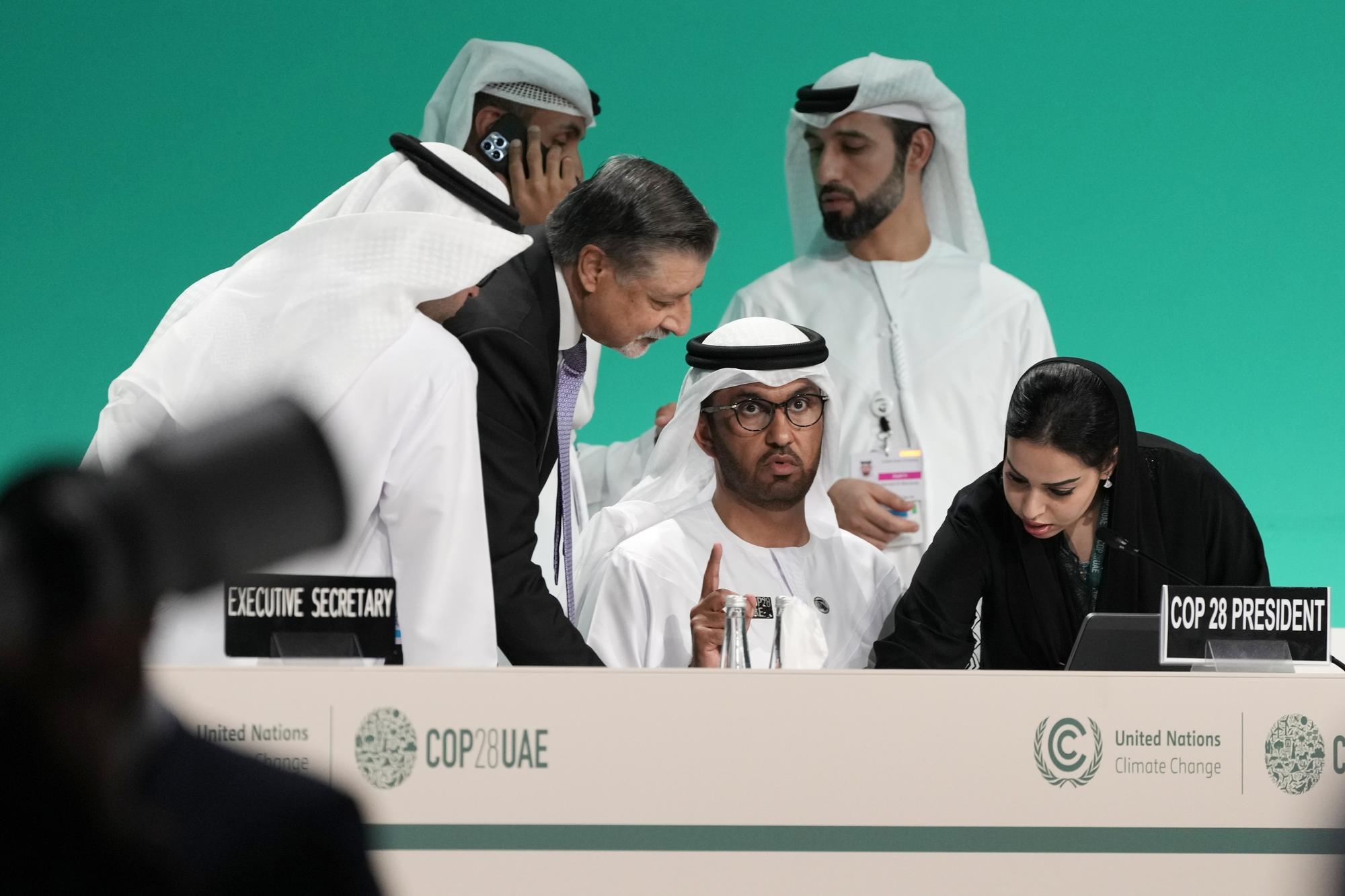 FILE - COP28 President Sultan al-Jaber prepares for a plenary session with COP28 CEO Adnan Amin at the COP28 U.N. Climate Summit, Friday, Dec. 1, 2023, in Dubai, United Arab Emirates. (AP Photo/Peter Dejong, File)