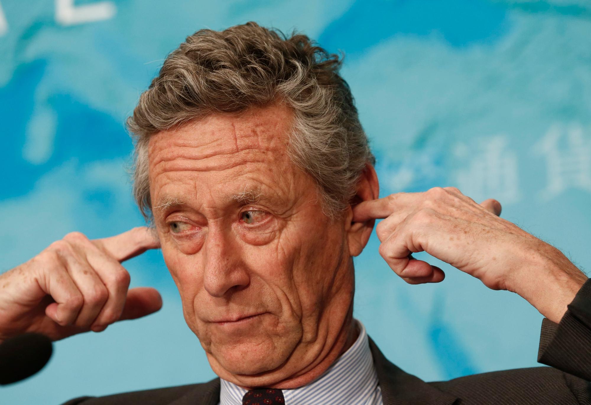 epa04570236 Olivier Blanchard, Economic Counselor and Director of Research of the International Monetary Fund (IMF), gestures for an earpiece during a press conference on the IMF World Economic Outlook update in Beijing, China, 20 January 2015. The IMF trimmed its global economic growth forecast for 2015 by 0.3 percentage points to 3.5 percent. The revision of the Washington-based crisis lender's previous forecast in October was due to slower growth in China, Russia, the eurozone and Japan, and reduced activities of oil-exporting countries. EPA/ROLEX DELA PENA