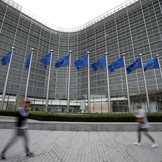 FILE - European Union flags wave in the wind as pedestrians walk by EU headquarters in Brussels, on Sept. 20, 2023. The European Union said Monday Dec. 18, 2023 that it has imposed fresh sanctions on Russia over its war against Ukraine, targeting the lucrative diamonds industry, more than 140 officials and organizations, and closing loopholes that Moscow has used to bypass previous punitive measures. (AP Photo/Virginia Mayo, File)