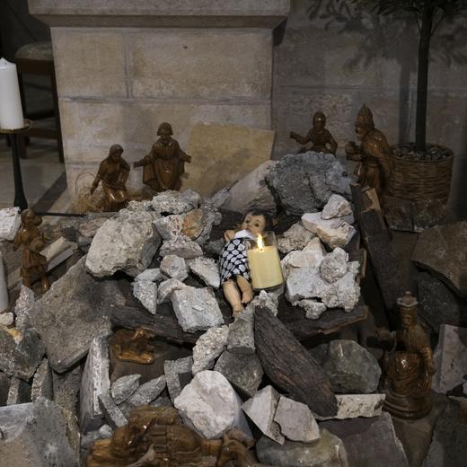 An installation of a scene of the Nativity of Christ with a figure symbolizing baby Jesus lying amid the rubble, in reference to Gaza, inside an Evangelical Lutheran Church in the West Bank town of Bethlehem, Sunday, Dec. 10, 2023. World-famous Christmas celebrations in Bethlehem have been put on hold due to the ongoing Israel-Hamas war. (AP Photo/Mahmoud Illean)