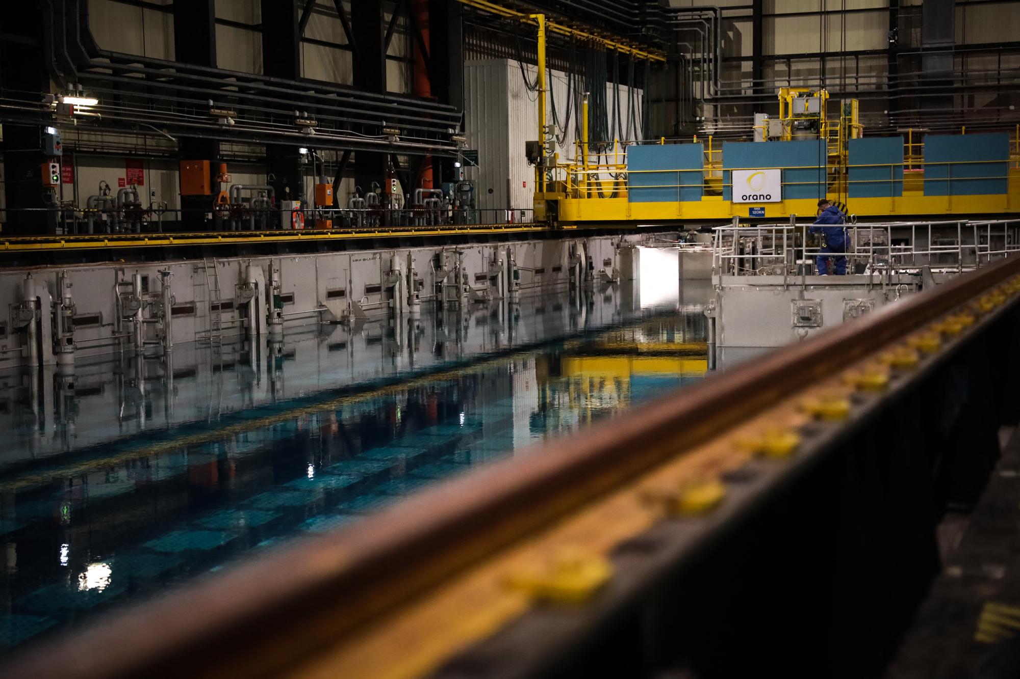 This photograph taken on December 14, 2022, shows a nuclear spent fuel pool (SFP) at the Orano la Hague reprocessing plant, in La Hague, northwestern France. A Spent Fuel Pool (SFP) is a temporary storage pool for spent nuclear fuel. (Photo by Lou BENOIST / AFP)